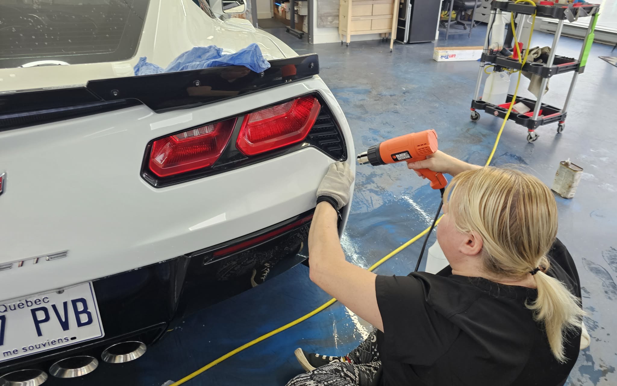 Detail de finition sur l'arriere d'une Corvette blanche dans l'atelier Teintage Express